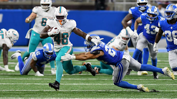 Miami Dolphins running back Aaron Shampklin (48) breaks a tackle against the Detroit Lions in the fourth quarter at Ford Field in the second preseason game.