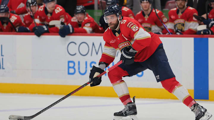 Mar 3, 2025; Sunrise, Florida, USA; Florida Panthers defenseman Aaron Ekblad (5) moves the puck against the Tampa Bay Lightning during the second period at Amerant Bank Arena. Mandatory Credit: Sam Navarro-Imagn Images