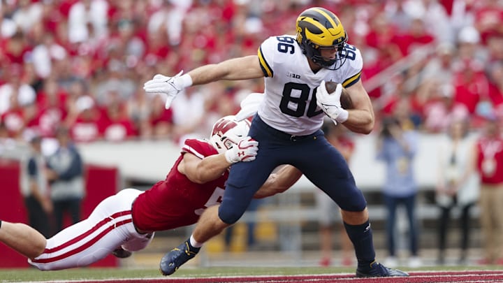 Oct 2, 2021; Madison, Wisconsin, USA;  Michigan Wolverines tight end Luke Schoonmaker (86) is tackled after catching a pass during the second quarter against the Wisconsin Badgers at Camp Randall Stadium. Mandatory Credit: Jeff Hanisch-Imagn Images