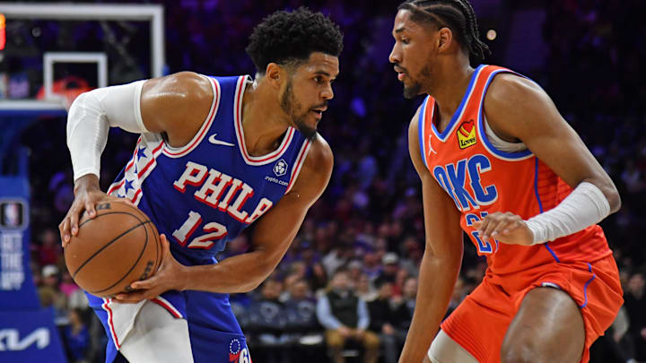Apr 2, 2024; Philadelphia, Pennsylvania, USA; Philadelphia 76ers forward Tobias Harris (12) is defended by Oklahoma City Thunder guard Aaron Wiggins (21) during the first quarter at Wells Fargo Center. Mandatory Credit: Eric Hartline-Imagn Images