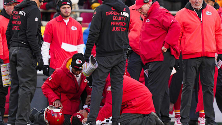 Dec 14, 2025; Kansas City, Missouri, USA; Kansas City Chiefs quarterback Patrick Mahomes (15) is attended to by team medical staff following an injury during the fourth quarter against the Los Angeles Chargers at GEHA Field at Arrowhead Stadium. Kansas City Chiefs head coach Andy Reid, second from right, watches. Mandatory Credit: Jay Biggerstaff-Imagn Images Dec 14, 2025; Kansas City, Missouri, USA; Kansas City Chiefs quarterback Patrick Mahomes (15) is attended to by team medical staff following an injury during the fourth quarter against the Los Angeles Chargers at GEHA Field at Arrowhead Stadium. Kansas City Chiefs head coach Andy Reid, second from right, watches. Mandatory Credit: Jay Biggerstaff-Imagn Images