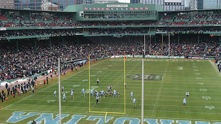 Dec 28, 2024; Boston, MA, USA; The Connecticut Huskies (white) and North Carolina Tar Heels (blue) compete during the second half at Fenway Park.