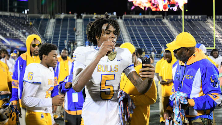 Miami Northwestern's Calvin Russell Jr. takes a selfie with his state medal after his team won the Class 3A championship against Raines on Dec. 14, 2024.