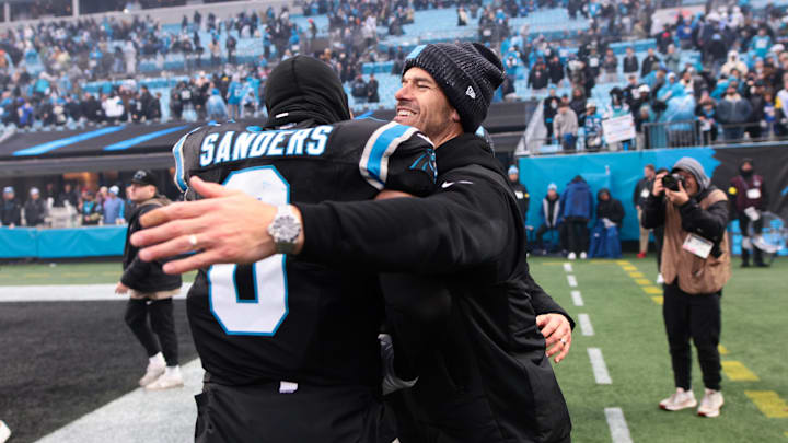 Nov 30, 2025; Charlotte, North Carolina, USA; Carolina Panthers head coach Dave Canales celebrates with Carolina Panthers tight end Ja'Tavion Sanders (0) after the game against the Los Angeles Rams at Bank of America Stadium. Mandatory Credit: Scott Kinser-Imagn Images Nov 30, 2025; Charlotte, North Carolina, USA; Carolina Panthers head coach Dave Canales celebrates with Carolina Panthers tight end Ja'Tavion Sanders (0) after the game against the Los Angeles Rams at Bank of America Stadium. Mandatory Credit: Scott Kinser-Imagn Images