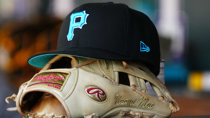 Detailed view of a Pittsburgh Pirates glove and cap in the dugout doing the game against the Colorado Rockies at Coors Field. Detailed view of a Pittsburgh Pirates glove and cap in the dugout doing the game against the Colorado Rockies at Coors Field.
