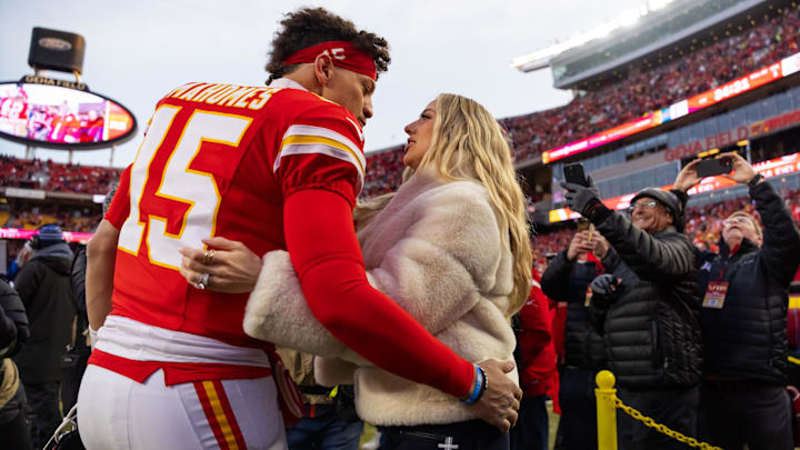 Kansas City Chiefs quarterback Patrick Mahomes (15) and wife Brittany Mahomes kiss before the AFC Championship game against the Buffalo Bills at GEHA Field at Arrowhead Stadium.