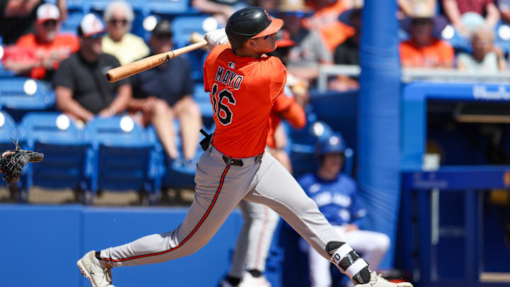 Mar 13, 2025; Dunedin, Florida, USA; Baltimore Orioles third baseman Coby Mayo (16) doubles against the Toronto Blue Jays in the second inning during spring training at TD Ballpark.