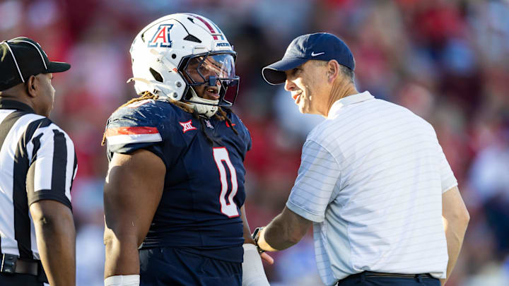 Nov 8, 2025; Tucson, Arizona, USA; Arizona Wildcats head coach Brent Brennan with defensive lineman Deshawn McKnight (0) against the Kansas Jayhawks in the second half at Arizona Stadium. Mandatory Credit: Mark J. Rebilas-Imagn Images