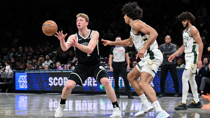 Dec 14, 2025; Brooklyn, New York, USA; Brooklyn Nets forward Danny Wolf (2) passes the ball as Milwaukee Bucks center Jericho Sims (00) defends during the second half at Barclays Center. Mandatory Credit: John Jones-Imagn Images