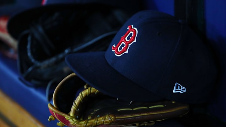 Jul 22, 2019; St. Petersburg, FL, USA; A detail view of Boston Red Sox hat and glove laying in the dugout at Tropicana Field. Mandatory Credit: Kim Klement-Imagn Images