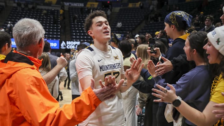 Jan 27, 2026; Morgantown, West Virginia, USA; West Virginia Mountaineers guard Treysen Eaglestaff (52) celebrates with fans after defeating the Kansas State Wildcats at Hope Coliseum. Mandatory Credit: Ben Queen-Imagn Imagesa Jan 27, 2026; Morgantown, West Virginia, USA; West Virginia Mountaineers guard Treysen Eaglestaff (52) celebrates with fans after defeating the Kansas State Wildcats at Hope Coliseum. Mandatory Credit: Ben Queen-Imagn Imagesa