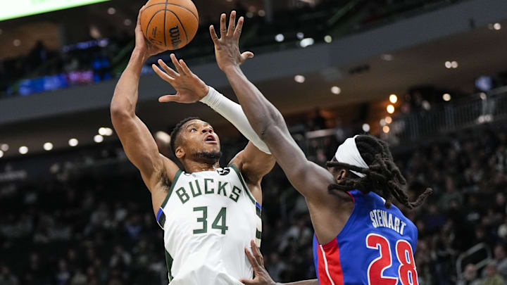 Nov 13, 2024; Milwaukee, Wisconsin, USA;  Milwaukee Bucks forward Giannis Antetokounmpo (34) shoots over Detroit Pistons forward Isaiah Stewart (28) during the first quarter at Fiserv Forum. Mandatory Credit: Jeff Hanisch-Imagn Images