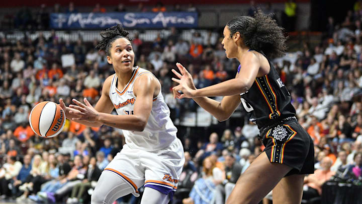 Jun 18, 2025; Uncasville, Connecticut, USA; Phoenix Mercury forward Alyssa Thomas (25) looks before shooting the ball against the defense of Connecticut Sun forward Olivia Nelson-Ododa (10) during the second half at Mohegan Sun Arena. Mandatory Credit: Eric Canha-Imagn Images