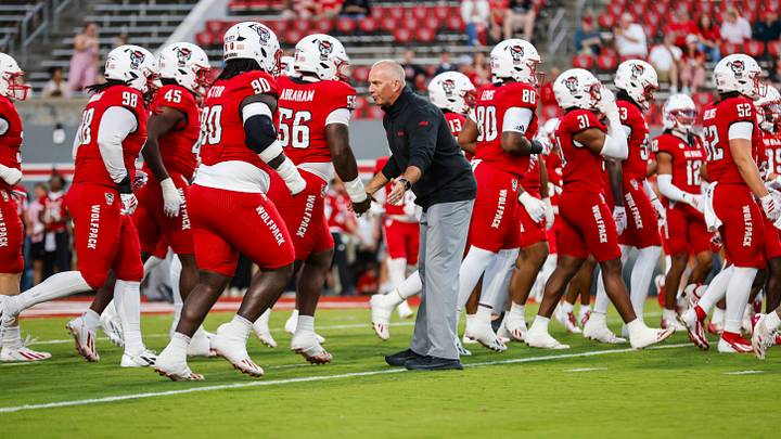 Sep 26, 2026; Raleigh, North Carolina, USA;  NC State Wolfpack head coach Dave Doeren peps his team up during warmups of the game against App State Mountaineers at Carter-Finley Stadium.  Mandatory Credit: Jaylynn Nash-Imagn Images