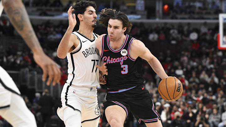 Dec 3, 2025; Chicago, Illinois, USA;  Chicago Bulls guard Josh Giddey (3) drives against Brooklyn Nets guard Ben Saraf (77) during the first half at the United Center. Mandatory Credit: Matt Marton-Imagn Images