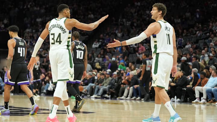 Mar 22, 2025; Sacramento, California, USA; Milwaukee Bucks forward Giannis Antetokounmpo (34) and center Brook Lopez (11) celebrate after defeating the Sacramento Kings at Golden 1 Center. Mandatory Credit: Darren Yamashita-Imagn Images