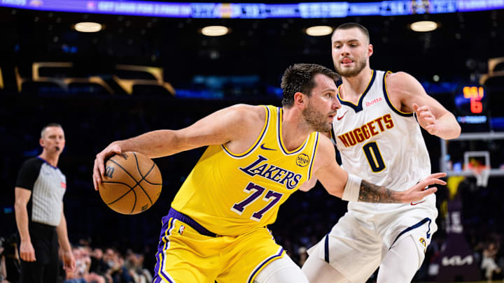 Mar 14, 2026; Los Angeles, California, USA; Los Angeles Lakers guard Luka Doncic (77) controls the ball while under pressure from Denver Nuggets guard Christian Braun (0) during the first half at Crypto.com Arena. Mar 14, 2026; Los Angeles, California, USA; Los Angeles Lakers guard Luka Doncic (77) controls the ball while under pressure from Denver Nuggets guard Christian Braun (0) during the first half at Crypto.com Arena.