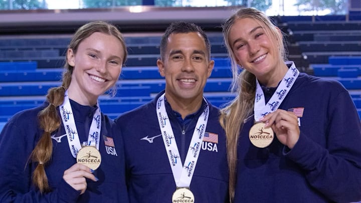 Nebraska volleyball players Bergen Reilly (left) and Andi Jackson (right) and assistant coach Jaylen Reyes (center) pose with their gold medals after winning the NORCECA U21 Continental Championship in Toronto.