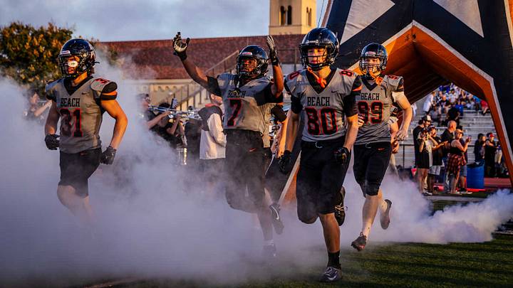Huntington Beach runs out onto the field before taking on Los Alamitos in Week 1.