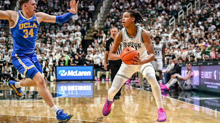 Michigan State's Jordan Scott, right, looks to pass as UCLA's Tyler Bilodeau closes in during the first half on Tuesday, Feb. 17, 2026, at the Breslin Center in East Lansing. Michigan State's Jordan Scott, right, looks to pass as UCLA's Tyler Bilodeau closes in during the first half on Tuesday, Feb. 17, 2026, at the Breslin Center in East Lansing.