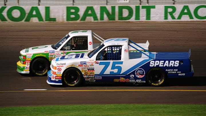 Apr 21, 1996; Avondale, Arizona, USA; NASCAR Craftsman Truck Series driver Bobby Gill (75) races alongside Jack Sprague (24) during the Desert Star Classic at Phoenix International Raceway. Apr 21, 1996; Avondale, Arizona, USA; NASCAR Craftsman Truck Series driver Bobby Gill (75) races alongside Jack Sprague (24) during the Desert Star Classic at Phoenix International Raceway.