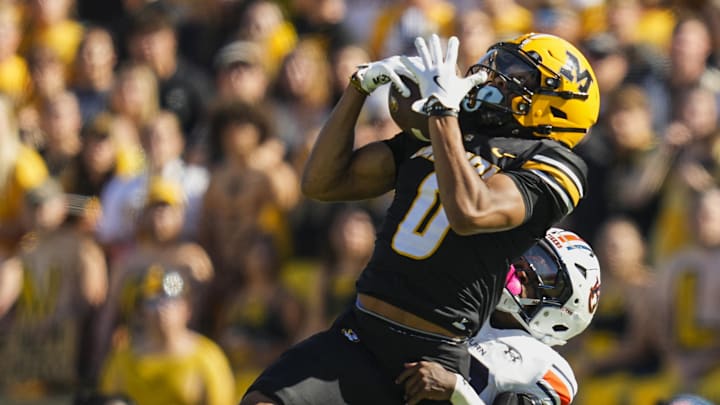 Oct 19, 2024; Columbia, Missouri, USA; Missouri Tigers wide receiver Joshua Manning (0) catches a pass against Auburn Tigers safety Sylvester Smith (19) during the first half at Faurot Field at Memorial Stadium. Mandatory Credit: Jay Biggerstaff-Imagn Images