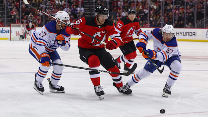 Dec 21, 2023; Newark, New Jersey, USA; New Jersey Devils defenseman John Marino (6) and Edmonton Oilers left wing James Hamblin (57) battle for the puck during the second period at Prudential Center. Mandatory Credit: Ed Mulholland-Imagn Images Dec 21, 2023; Newark, New Jersey, USA; New Jersey Devils defenseman John Marino (6) and Edmonton Oilers left wing James Hamblin (57) battle for the puck during the second period at Prudential Center. Mandatory Credit: Ed Mulholland-Imagn Images