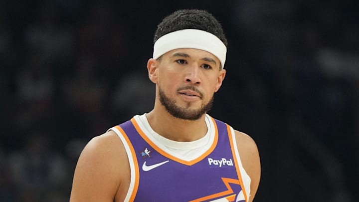 Feb 7, 2026; Phoenix, Arizona, USA; Phoenix Suns guard Devin Booker (1) reacts against the Philadelphia 76ers during the first half of an NBA game at Mortgage Matchup Center. Mandatory Credit: Rick Scuteri-Imagn Images