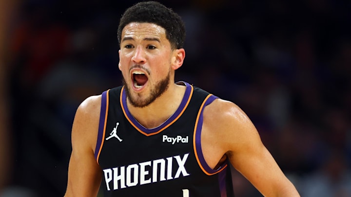 Apr 17, 2026; Phoenix, Arizona, USA; Phoenix Suns guard Devin Booker (1) reacts against the Golden State Warriors during the first half in the play-in rounds of the 2026 NBA Playoffs at Mortgage Matchup Center. Mandatory Credit: Mark J. Rebilas-Imagn Images

