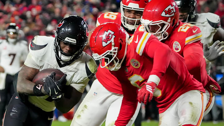 Dec 7, 2025; Kansas City, Missouri, USA; Houston Texans running back Woody Marks (27) runs the ball against Kansas City Chiefs safety Bryan Cook (6) during the fourth quarter at GEHA Field at Arrowhead Stadium. Mandatory Credit: Denny Medley-Imagn Images