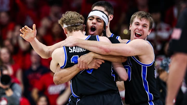 Feb 22, 2025; Tucson, Arizona, USA; BYU Cougars center Keba Keita (13), guard Trey Stewart (1) and guard Dallin Hall (30) celebrate a win against the Arizona Wildcats at the end of the game at McKale Center. Mandatory Credit: Aryanna Frank-Imagn Images