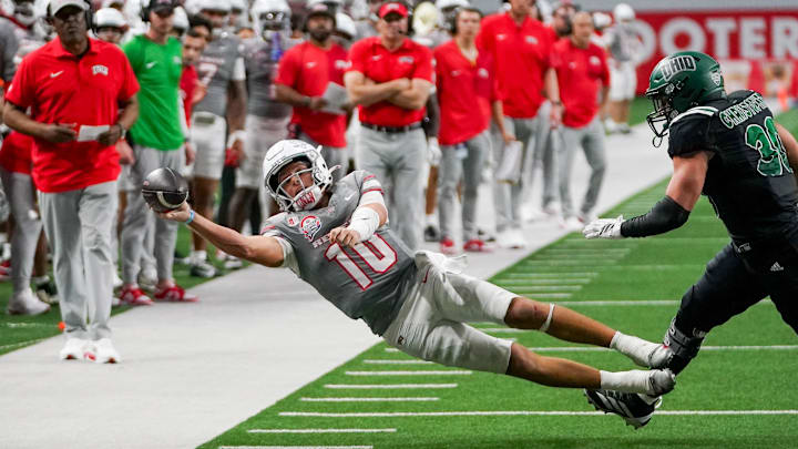 Dec 23, 2025; Frisco, TX, USA;  UNLV Rebels quarterback Anthony Colandrea (10) attempts a pass as he is chased by Ohio Bobcats linebacker Charlie Christopher (30) during the second half at the Ford Center at The Star. Mandatory Credit: Raymond Carlin III-Imagn Images