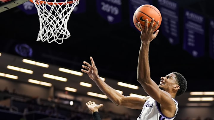 Dec 30, 2024; Manhattan, Kansas, USA; Kansas State Wildcats guard David N'Guessan (1) shoots against Cincinnati Bearcats forward Dillon Mitchell (23) during the second half at Bramlage Coliseum. Mandatory Credit: Jay Biggerstaff-Imagn Images