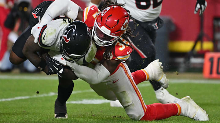 Dec 7, 2025; Kansas City, Missouri, USA; Kansas City Chiefs linebacker Nick Bolton (32) tackles Houston Texans running back Woody Marks (27) during the third quarter at GEHA Field at Arrowhead Stadium. Mandatory Credit: Amy Kontras-Imagn Images