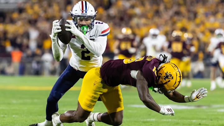 Nov 28, 2025; Tempe, Arizona, USA; Arizona Wildcats defensive back Treydan Stukes (2) intercepts the ball against Arizona State Sun Devils wide receiver Jaren Hamilton (16) in the second half during the 99th Territorial Cup at Mountain America Stadium. Mandatory Credit: Mark J. Rebilas-Imagn Images