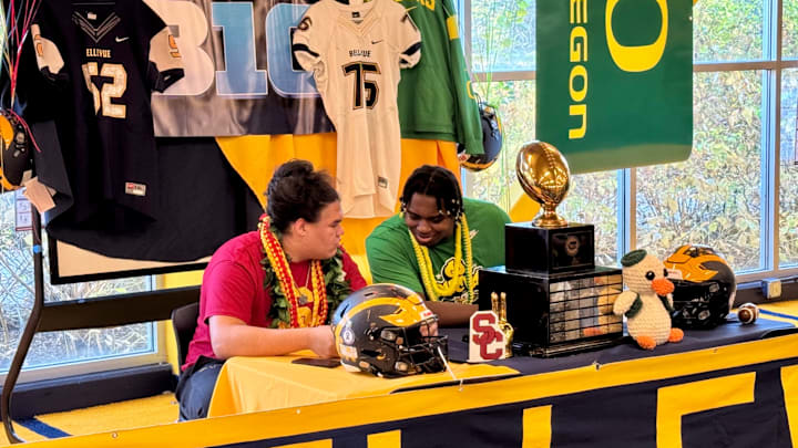 Bellevue offensive linemen Willi Wascher (USC), left, and Demetri Manning (Oregon) sign their letters of intent in the early period Wednesday at school.