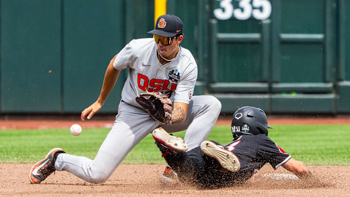 Jun 17, 2025; Omaha, Neb, USA; Louisville Cardinals center fielder Lucas Moore (53) steals second against Oregon State Beavers shortstop Aiva Arquette (13) during the third inning at Charles Schwab Field. Mandatory Credit: Dylan Widger-Imagn Images