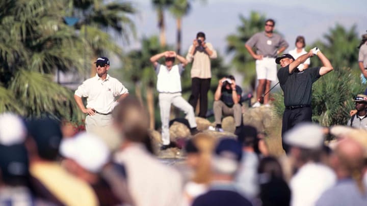 David Duval (left) watches as Tom Lehman drives in a later edition of the Skins Game.