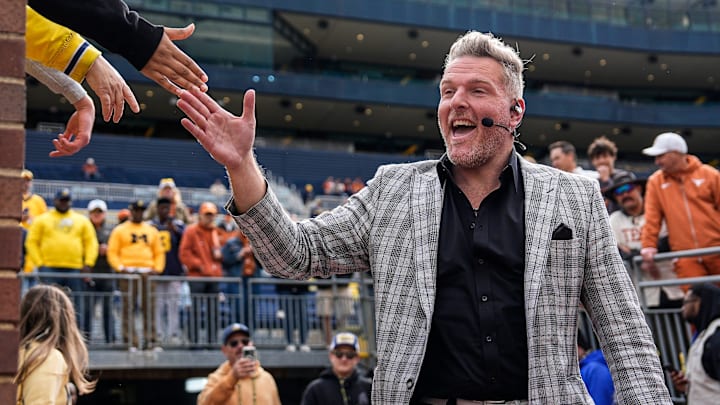 ESPN College Game Day's Pat McAfee high-fives fans as he takes the field before the game between Michigan and Texas at Michigan Stadium in Ann Arbor on Saturday, September 7, 2024.
