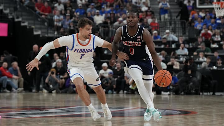 Nov 3, 2025; Las Vegas, NV, USA; Arizona Wildcats guard Jaden Bradley (0) dribbles against Florida Gators guard Urban Klavzar (7) during the second half of the Hall of Fame Series game at T-Mobile Arena. Mandatory Credit: Candice Ward-Imagn Images
