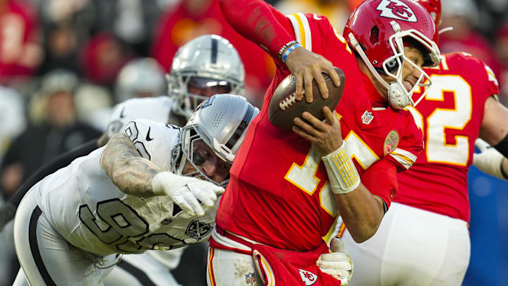 Nov 29, 2024; Kansas City, Missouri, USA; Kansas City Chiefs quarterback Patrick Mahomes (15) scrambles from Las Vegas Raiders defensive end Maxx Crosby (98) during the second half at GEHA Field at Arrowhead Stadium. Mandatory Credit: Jay Biggerstaff-Imagn Images