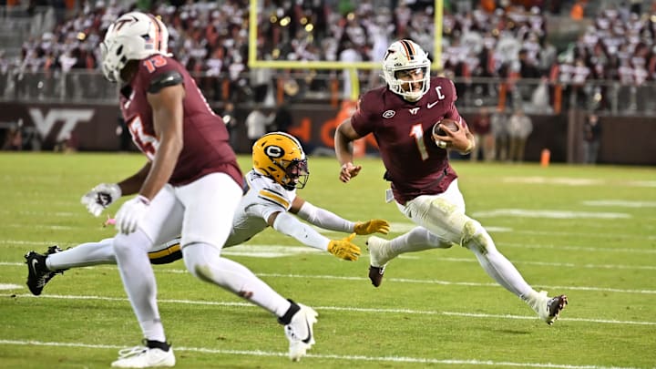 Virginia Tech quarterback Kyron Drones (1) eludes Cal defensive back Jordan Sanford Virginia Tech quarterback Kyron Drones (1) eludes Cal defensive back Jordan Sanford