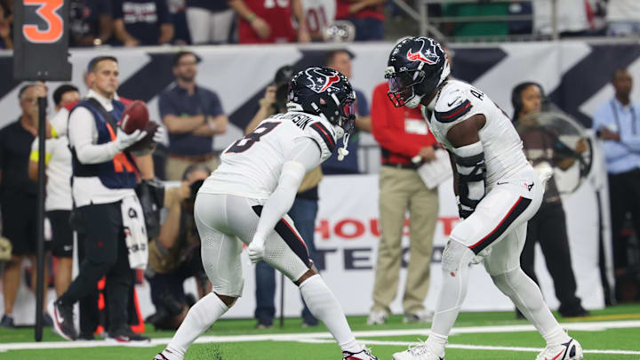 Sep 15, 2025; Houston, Texas, USA; Houston Texans safety C.J. Gardner-Johnson (8) and Houston Texans linebacker Azeez Al-Shaair (0) celebrate after making a tackle during the second quarter against the Tampa Bay Buccaneers at NRG Stadium. Mandatory Credit: Thomas Shea-Imagn Images
