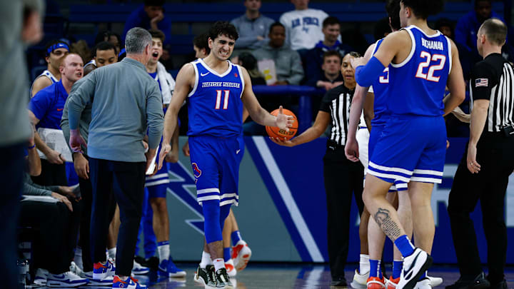 Boise State guard Alvaro Cardenas reacts with head coach Leon Rice and teammates.