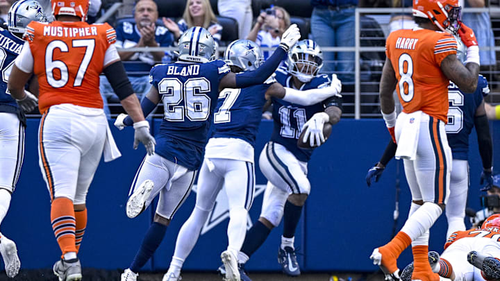 Dallas Cowboys cornerbacks DaRon Bland and Trevon Diggs celebrate Micah Parsons' fumble return for a touchdown against the Chicago Bears.