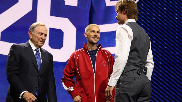 Jun 26, 2026; Buffalo, New York, USA; Gavin McKenna talks to NHL commissioner Gary Bettman and singer Justin Bieber after being selected with the first pick in the first round of the 2026 NHL Draft by the Toronto Maple Leafs at KeyBank Center. Mandatory Credit: Timothy T. Ludwig-Imagn Images
