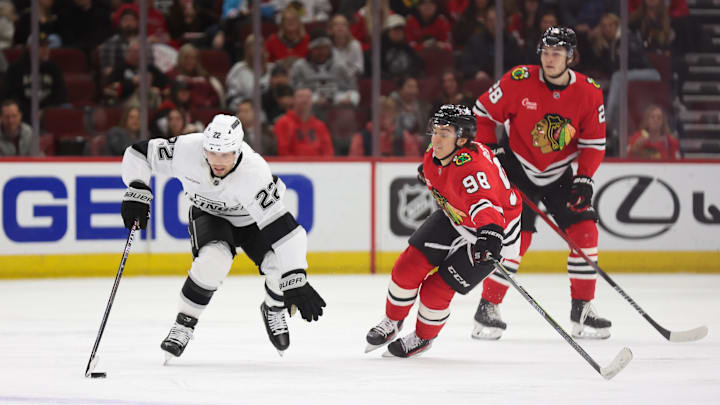 Mar 20, 2025; Chicago, Illinois, USA; Los Angeles Kings left wing Kevin Fiala (22) and Chicago Blackhawks center Connor Bedard (98) battle for control of the puck during the third period at United Center. Mandatory Credit: Talia Sprague-Imagn Images