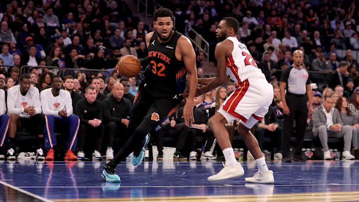 Nov 14, 2025; New York, New York, USA; New York Knicks center Karl-Anthony Towns (32) drives to the basket against Miami Heat forward Andrew Wiggins (22) during the second quarter at Madison Square Garden. Mandatory Credit: Brad Penner-Imagn Images