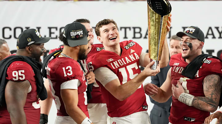 Jan 19, 2026; Miami Gardens, FL, USA; Indiana Hoosiers quarterback Fernando Mendoza (15) lifts the trophy after the College Football Playoff National Championship game against the Miami Hurricanes at Hard Rock Stadium. 
