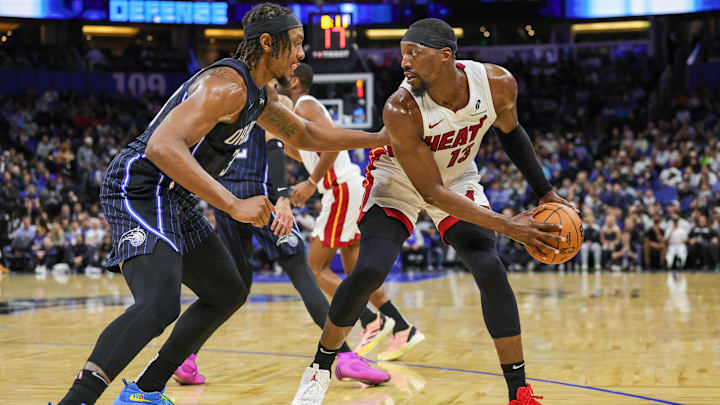 Dec 26, 2024; Orlando, Florida, USA; Miami Heat center Bam Adebayo (13) handles the ball in front of Orlando Magic center Wendell Carter Jr. (34) during the second quarter at Kia Center. Mandatory Credit: Mike Watters-Imagn Images